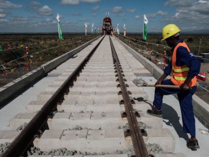 A Kenyan worker puts gravel at the construction site of Standard Gauge Railway (SGR) during the Presidential Inspection of the SGR Nairobi-Naivasha Phase 2A project in Nairobi, Kenya, on June 23, 2018. - The SGR phase 2A project is an 120km extensiton of the Monbasa-Nairobi SGR project (Phase 1) with …
