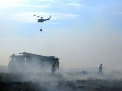 Firefighters beat out wildfires on Winter Hill near Rivington in Lancashire, north west En