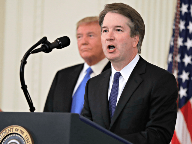 President Donald Trump listens as Judge Brett Kavanaugh his Supreme Court nominee speaks,