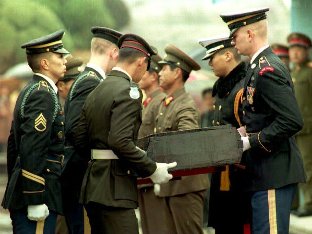 North Korean soldiers hand over remains of U.S servicemen killed during the Korean War to