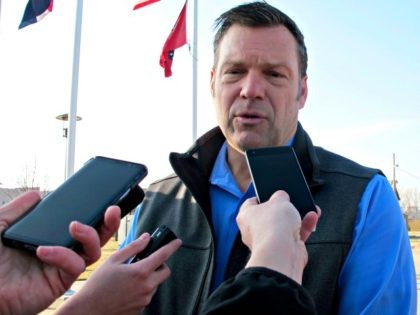 Kansas Secretary of State Kris Kobach answers questions from reporters after announcing hi
