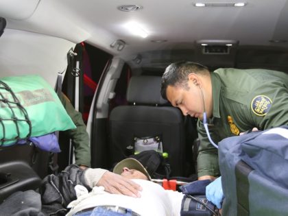 A Laredo Sector Border Patrol agent administers life-saving fluids to an illegal alien suffering from the Texas heat. (Photo: U.S. Border Patrol/Laredo Sector)
