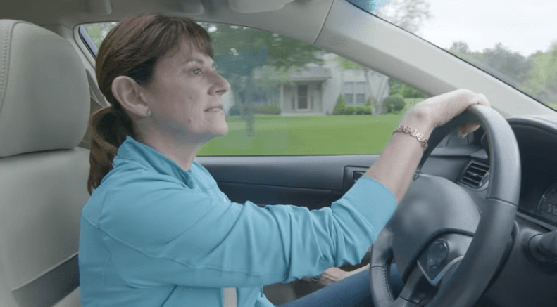 Leah Vukmir appears in a campaign ad driving a car with a blurred Toyota logo.