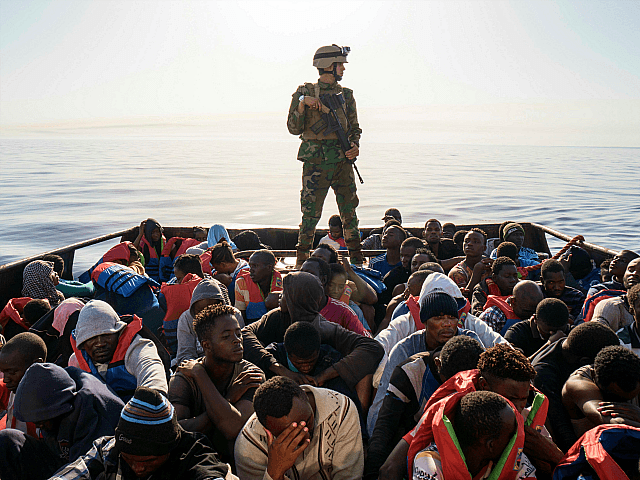 A Libyan coast guardsman stands on a boat during the rescue of 147 illegal immigrants attempting to reach Europe off the coastal town of Zawiyah, 45 kilometres west of the capital Tripoli, on June 27, 2017. More than 8,000 migrants have been rescued in waters off Libya during the past …