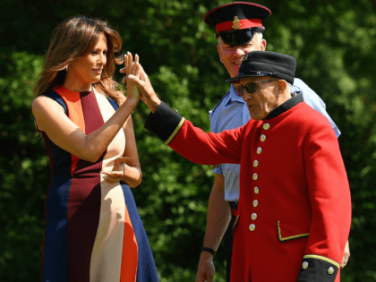 LONDON, ENGLAND - JULY 13: First Lady, Melania Trump, high-fives a Chelsea Pensioners as s