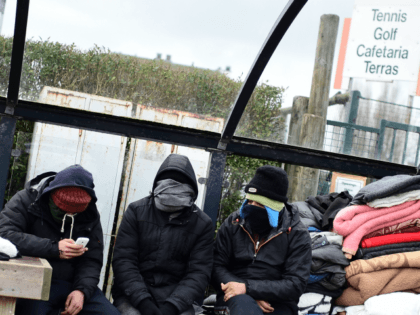 Migrants live in a park in the Belgian port city of Zeebrugge, on February 4, 2016. Some migrants are heading to the Belgian coast, to try and smuggle themselves on bound ferries to reach Britain. Belgian police are cracking down on migrants arriving in Zeebrugge, with more than 450 people …
