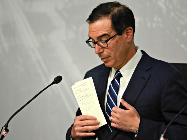U.S. Treasury Secretary Steven Mnuchin puts away his notes during a press conference at th