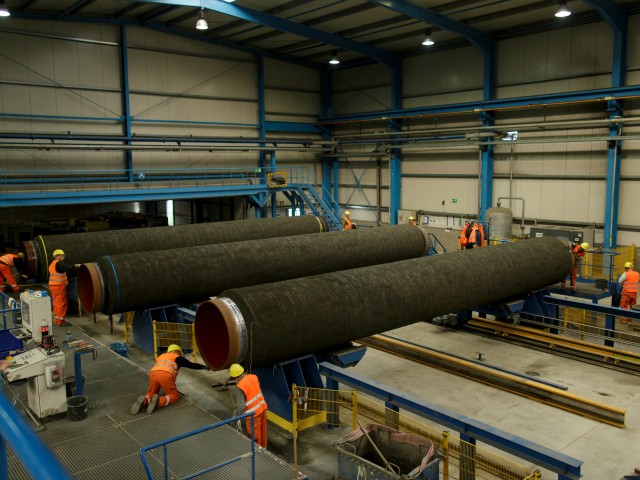 Workers are working on pipes in the production hall at the Nord Stream 2 facility at Mukran on Ruegen Islandon October 19, 2017 in Sassnitz, Germany. Nord Stream is laying a second pair of offshore pipelines in the Baltic Sea between Vyborg in Russia and Greifswald in Germany for the transportation of Russian natural gas to western Europe. An initial pair of pipelines was inaugurated in 2012 and the second pair is due for completion by 2019. A total of 50,000 pipes are currently on hand at Mukran, where they receive a concrete wrapping before being transported out to sea. Russian energy supplier Gazprom, whose board is led by former German chancellor Gerhard Schroeder, owns a 51% stake in Nord Stream. (Photo by Carsten Koall/Getty Images)