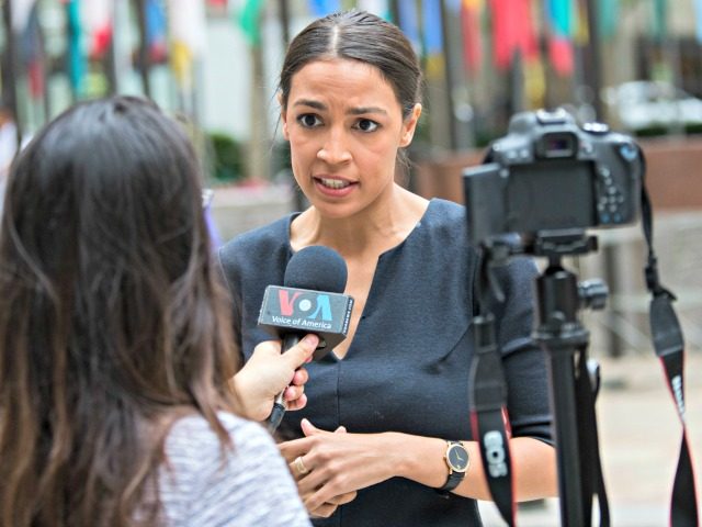 Alexandria Ocasio-Cortez, a winner of a Democratic Congressional primary in New York speaks to a reporter, Wednesday, June 27, 2018, in New York. The 28-year-old political newcomer who upset U.S. Rep. Joe Crowley in New York's Democrat primary says she brings an "urgency" to the fight for working families.