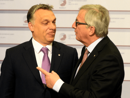 Hungarian Prime Minister Viktor Orban is greeted by President of the European Commission Jean-Claude Juncker on the second day of the fourth European Union (EU) eastern Partnership Summit in Riga, on May 22, 2015 as Latvia holds the rotating presidency of the EU Council. EU leaders and their counterparts from …