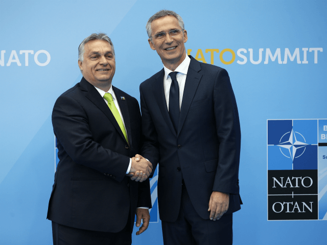 Hungarian Prime Minister Viktor Orban (L) is welcomed by NATO Secretary General Jens Stolt