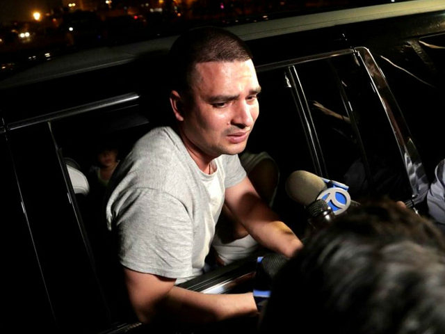 Pablo Villavicencio leans out of an SUV while talking to reporters after being released fr