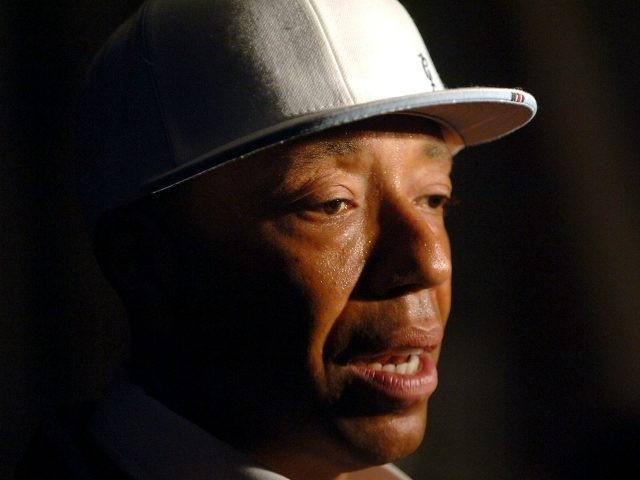 Music producer Russell Simmons arrives backstage at the Baby Phat Spring 2006 fashion show