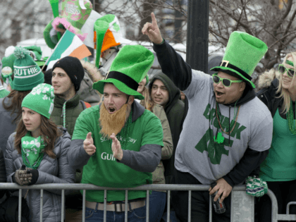 Spectators cheer during the annual St. Patrick's Day parade in Boston, Sunday, March 19, 2017. Tens of thousands of people lined the streets for the parade which went off amid high spirits and without a hitch after a dispute over whether a gay veterans group could march.(AP Photo/Michael Dwyer)