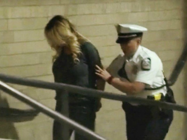 In this frame from video, porn actress Stormy Daniels is led into jail in Columbus, Ohio., after being taken into custody during a Wednesday evening, July 11, 2018, show. Daniels was arrested at a strip club and is accused of letting patrons touch her in violation of a state law, …