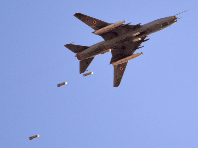 A Sukhoi Su-22 Syrian army plane releases bombs over southern Damascus in the area of Yarm