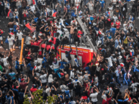 TOPSHOT-FBL-WC-2018-FRA-CRO-FANS This picture taken from the terrace of the Publicis drugstore on July 15, 2018 shows people standing on a firefighter vehicle after France won the Russia 2018 World Cup final football match between against Croatia, on the Champs-Elysees avenue in Paris.