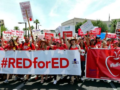 PHOENIX, AZ - APRIL 26: Arizona teachers march through downtown Phoenix on their way to the State Capitol as part of a rally for the #REDforED movement on April 26, 2018 in Phoenix, Arizona. Teachers state-wide staged a walkout strike on Thursday in support of better wages and state funding …