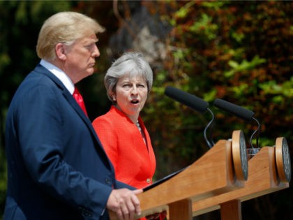British Prime Minister Theresa May, center, looks over toward President Donald Trump during their joint news conference at Chequers, in Buckinghamshire, England, Friday, July 13, 2018. (AP Photo/Pablo Martinez Monsivais)