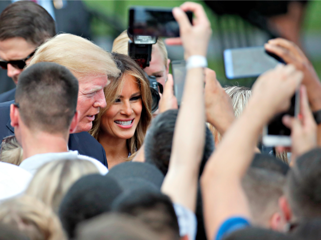 Trump July Fourth President Donald Trump, accompanied by first lady Melania Trump, greets