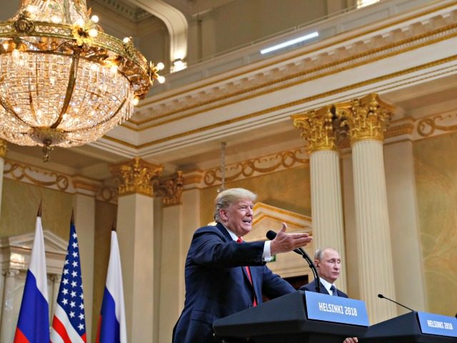 U.S. President Donald Trump, center, gestures while speaking as Russian President Vladimir