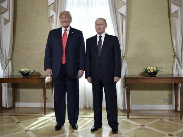US President Donald Trump (L) and Russia's President Vladimir Putin pose ahead a meeting i