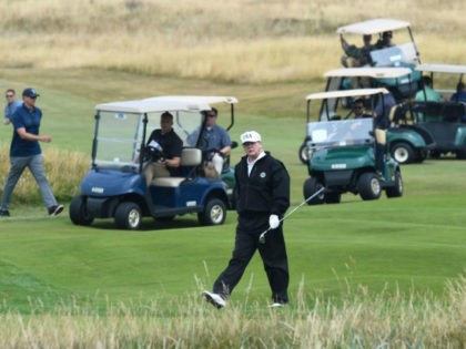 President Donald Trump walks as he plays a round of golf on the Ailsa course at Trump Turn