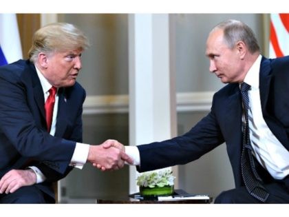 Russian President Vladimir Putin (R) and US President Donald Trump shake hands before a meeting in Helsinki, on July 16, 2018.