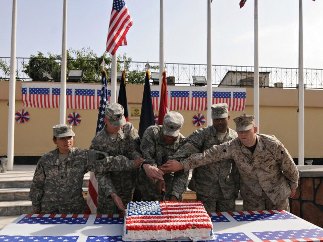US soldiers cut a cake in celebration of the 4th of July, the US Independence Day, on July