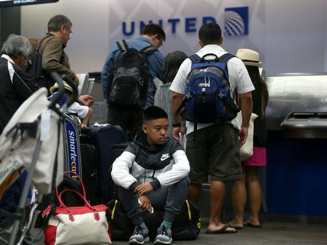United Airlines passengers wait in line to check in for flights at San Francisco Internati
