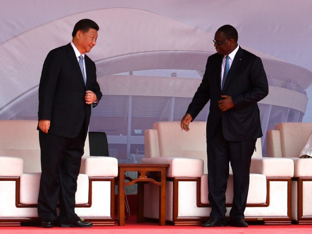 Chinese President Xi Jinping (L) and Senegalese President Macky Sall speak as they arrive for the inauguration ceremony of a wrestling arena built by a Chinese company in Dakar on July 22, 2018. - China's President Xi Jinping inked a clutch of trade accords on July 21 on the first …