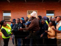 People queue early morning on July 30, 2018 at a polling station in the Harare suburb of Chitungwiza during Zimbabwe's 2018 general elections to elect the president and members of Parliament. (Photo by ALEX MCBRIDE / AFP) (Photo credit should read ALEX MCBRIDE/AFP/Getty Images)