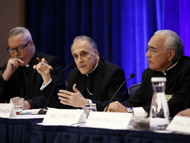 Cardinal Daniel DiNardo of the Archdiocese of Galveston-Houston, center, president of the United States Conference of Catholic Bishops, speaks at a news conference alongside Bishop Christopher Coyne of Burlington, Vt., left, and Bishop Joe Vasquez of Austin, Texas, during the USCCB's annual fall meeting in Baltimore, Monday, Nov. 13, 2017. …