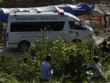 An ambulance with flashing lights leaves the cave rescue area in Mae Sai, Chiang Rai provi