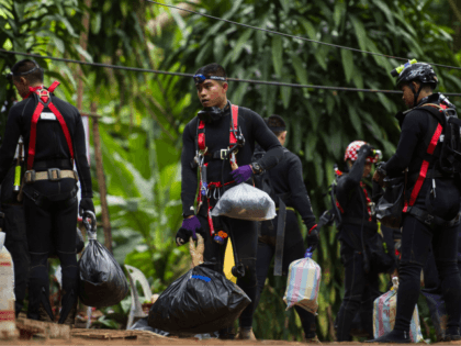 Thai divers carry supplies as rescue operations continue for 12 boys and their coach trapped at Tham Luang cave at Khun Nam Nang Non Forest Park in the Mae Sai district of Chiang Rai province on July 5, 2018. - Thai rescuers vowed to take a 'no risk' approach to …