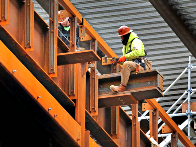 BOSTON, MA - MARCH 6: A construction worker works on a beam at The Hub on Causeway next to TD Garden in Boston on March 6, 2018.