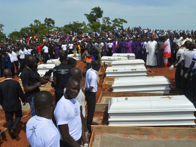Coffins are prepared for burial during a funeral service for 17 worshippers and two priest