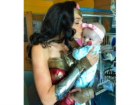 gal-gadot-visits-hospital-as-wonder-woman-ap This image released by Kelly Swink Sahady shows Gal Gadot, dressed as Wonder Woman kissing Sahady's daughter Karalyne during a visit to Inova Children's Hospital in Falls Church, Va. Gadot signed autographs and posed for photos with patients and staffers and they posted some of the pictures to social media. …