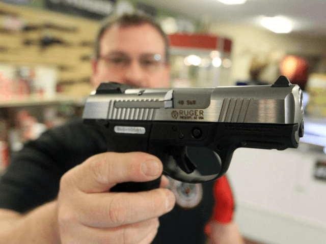 Gun retailer Steven King holds a Ruger SR40C at his Bridgeton, Missouri, shop. Wednesday, investors in Sturm, Ruger & Co. voted to have the gun-maker conduct a firearms safety report. File Photo by Bill Greenblatt/UPI