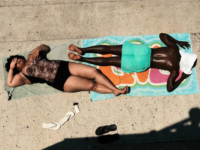 People enjoy a hot afternoon at the Astoria Pool in the borough of Queens on July 2, 2018