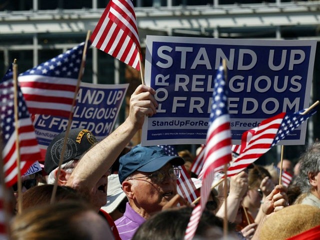 Flags and signs are held during a rally for religious freedom organized in part by the Cat