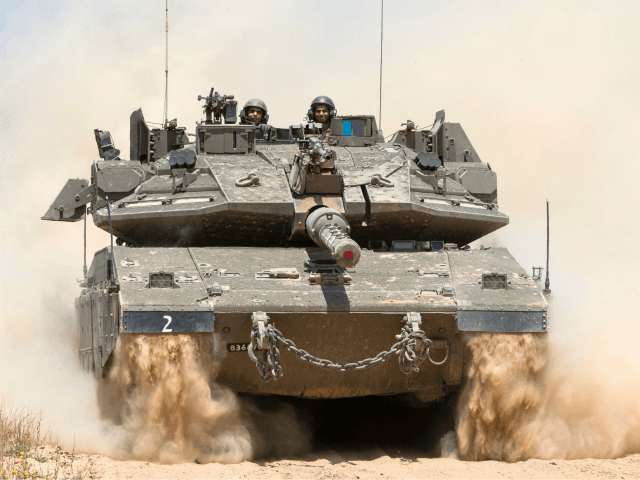 An Israeli tank rolls along the border between Israel and the Gaza Strip on May 6, 2016 as Israeli forces search for infiltration tunnels leading into southern Israel. Three days of mortar and tank fire between Israel and Palestinian militants, as well as Israeli air strikes, have raised concerns of …