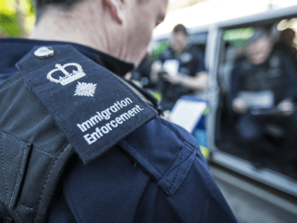 LONDON, UNITED KINGDOM - MAY 21: Immigration enforcement officers listen to a brief on the occupants of the houses they are about to raid for illegal immigrants, on May 21, 2015 in London, England. Despite pledging in 2010 to reduce migration numbers to less than 100,000, new immigration figures reveal …
