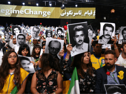 People hold pictures of relatives killed by the Mohllas regime, during 'Free Iran 2018 - the Alternative' event on June 30, 2018 in Villepinte, north of Paris during the Iranian resistance national council (CNRI) annual meeting. (Photo by Zakaria ABDELKAFI / AFP) (Photo credit should read ZAKARIA ABDELKAFI/AFP/Getty Images)