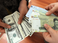 This picture illustrates Iranians on January 12, 2012 counting and exchanging the United States 100-dollar bills and Iran's Rial banknotes, bearing a portrait of Iran's late founder of Islamic Republic Ayatollah Ruhollah Khomeini in Tehran. The Rial's plunge, to 18,000 to the dollar hit a record low on January 18, …