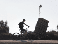 iron dome TEL AVIV, ISRAEL - AUGUST 31: (ISRAEL OUT) An Israeli man rides his bicycle past the 'Iron Dome' missile defense system as it is deployed on August 31, 2013 in Tel Aviv, Israel. Tensions are rising in Israel amid international talks of a military intervention In Syria. (Photo by Uriel …
