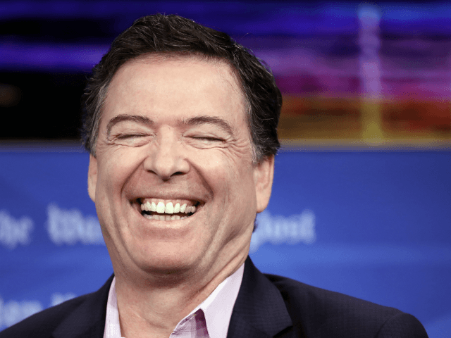 Former FBI director James Comey laughs while answering questions during an interview forum