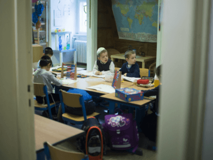 Pupils attend a math lesson during the visit of Ashkenazi Chief Rabbi of Israel at the Or Avner traditional Jewish school in Berlin, on November 8, 2013. David Lau visited the school to speak about the Kristallnacht aka Night of broken glasses, the November 1938 anti-Jewish pogrom as events get …