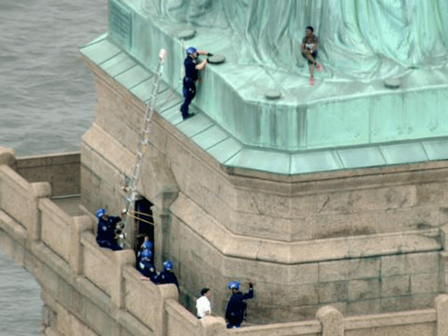 Woman Scales Statue of Liberty After Ten 'Abolish ICE' Protestors Arrested