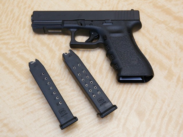 In this Tuesday, June 27, 2017 photo, a semi-automatic hand gun is displayed with a 10 shot magazine, left, and a 15 shot magazine, right, at a gun store in Elk Grove, Calif. A federal judge is blocking a California law set to go into effect Saturday, July 1, that would have barred gun owners from possessing high-capacity ammunition magazines. San Diego-based U.S. District Judge Roger Benitez said in ruling Thursday, June 29, that the law banning possession of magazines containing more than 10 bullets would have made criminals of thousands of otherwise law-abiding citizens who now own the magazines. (AP Photo/Rich Pedroncelli)